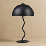 Madison black metal table lamp on a warm beige Elara studio floor