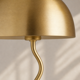 Madison lamp close-up showing brushed gold dome rim and sculptural wavy stem
