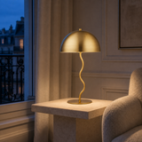 Madison gold metal table lamp in a refined blue-hour European reading nook