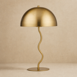 Madison gold metal table lamp on a warm beige Elara studio floor
