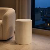 Majolica ivory ceramic tile stool in a refined blue-hour reading corner