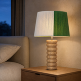 Marco wood lamp glowing in a refined blue-hour bedroom