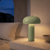 Moderno sage green touch lamp in a Mediterranean bedroom at dusk