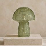 Green mushroom glass LED lamp in a warm beige Elara studio