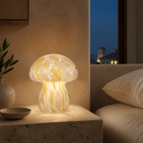 Mushroom glass LED lamp glowing softly at blue hour
