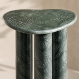 Close-up of the dark green veined stone finish and rounded organic tabletop