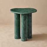 Nettuno green stone side table in a warm beige studio