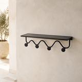Oriel black metal wall shelf and four-hook rack in a Mediterranean entryway
