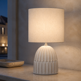 Paige ceramic table lamp glowing in a refined evening interior