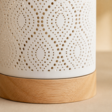 Close-up of Palm perforated white finish and natural wood base