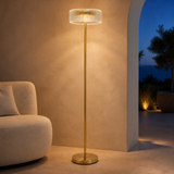 Park brass and ribbed glass floor lamp glowing in a refined interior