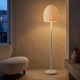 Perline wood bead floor lamp softly glowing in an elegant evening interior
