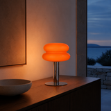 Peyton orange glass and chrome table lamp in an elegant evening interior
