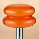 Close-up of the Peyton translucent orange glass and polished chrome finish