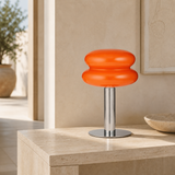 Peyton orange glass and chrome table lamp in a premium Mediterranean interior