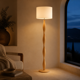 Priya natural wood floor lamp in an evening Mediterranean interior
