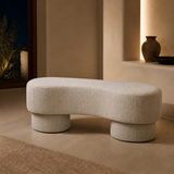 Riviera ivory upholstered bench in a warm evening interior