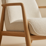 Close-up of Rowan Occasional Chair natural wood frame and cream upholstery
