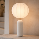 Shelton Ceramic Lamp White glowing in a warm evening interior