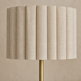 Close-up of the Sombra Gold Natural lamp pleated linen shade