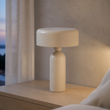 Sombra warm stone lamp in a minimalist bedroom at dusk