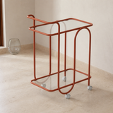 Elevated angle of the Trinità coral metal and glass trolley