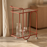 Trinità coral metal and glass trolley in a Mediterranean entertaining corner