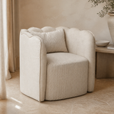 Tullio striped scalloped accent chair in a Mediterranean reading corner