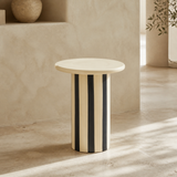 Tyra striped cylindrical side table in a minimal Mediterranean interior