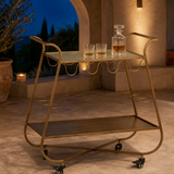 Grazia Gold Bar Trolley on a Mediterranean terrace at dusk