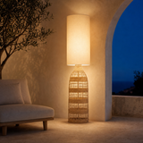 Hampton Woven Floor Lamp Natural on a Mediterranean terrace at dusk