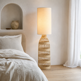 Hampton Woven Floor Lamp Natural in a refined European bedroom