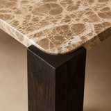 Close-up of Valencia brecciated marble rounded corner fitted into an espresso mango wood block leg