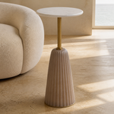 Venetia marble and brass side table with blush fluted base in a European coastal interior