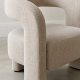 Close detail of Ventoux fine ivory-oat flecked upholstery where the rounded horseshoe arm continues into the front block leg beside the single thick seat