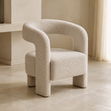 Ventoux natural flecked upholstered armchair with continuous horseshoe back and arms, open back, one thick seat and exactly four block legs, alternate lifestyle angle