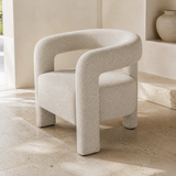 Ventoux natural flecked upholstered armchair from an elevated rear angle showing the continuous horseshoe back and arms, open back and four block legs