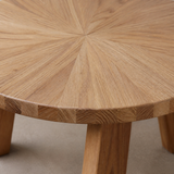 Close detail of the Verona coffee table radial sunburst wood grain, laminated rounded edge and slab leg joinery