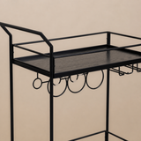 Close detail of the Walker black wood-grain upper tray, tubular guard rails, elevated handle supports, circular bottle rings and stemware guides