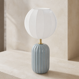 Elevated angle of the Wilton fluted blue-grey ceramic lamp showing its small top opening and large flattened balloon shade