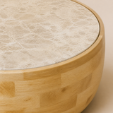 Close detail of the Zahara cream-beige veined marble disc, thin rounded mango wood rim and staggered honey wood block body