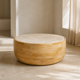 Alternate lifestyle angle of the Zahara low round cream marble and honey mango wood drum coffee table