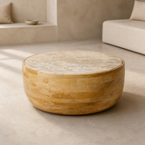 Zahara low round coffee table with inset cream-beige marble disc and convex honey mango wood block drum body in a premium Mediterranean interior